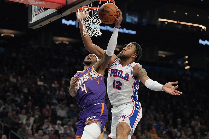 Feb 7, 2026; Phoenix, Arizona, USA; Phoenix Suns guard Jalen Green (4) scores over Philadelphia 76ers forward Trendon Watford (12) during the first half of an NBA game at Mortgage Matchup Center. Mandatory Credit: Rick Scuteri-Imagn Images
