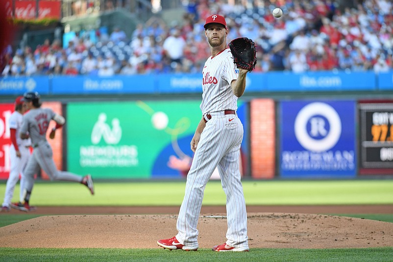 Jul 21, 2025; Philadelphia, Pennsylvania, USA; Philadelphia Phillies pitcher Zack Wheeler (45) gets anew baseball after allowing a home run to Boston Red Sox outfielder Jarren Duran (16) during the first inning against the Boston Red Sox at Citizens Bank Park. Mandatory Credit: Eric Hartline-Imagn Images