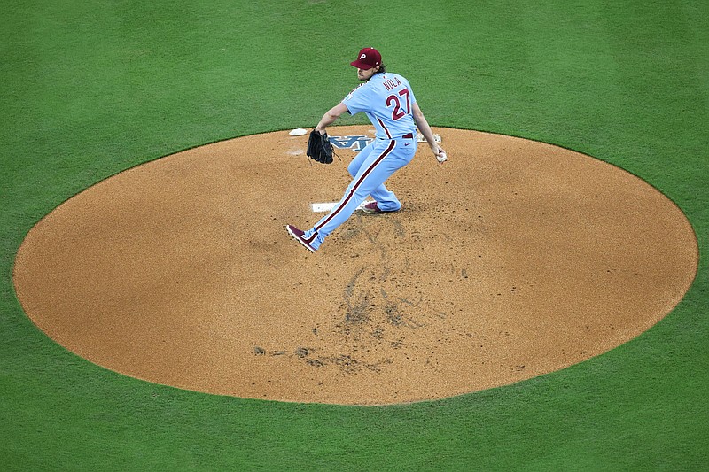 Oct 8, 2025; Los Angeles, California, USA; Philadelphia Phillies pitcher Aaron Nola (27) pitches during the first inning against the Los Angeles Dodgers during game three of the NLDS round for the 2025 MLB playoffs at Dodger Stadium. Mandatory Credit: Kiyoshi Mio-Imagn Images