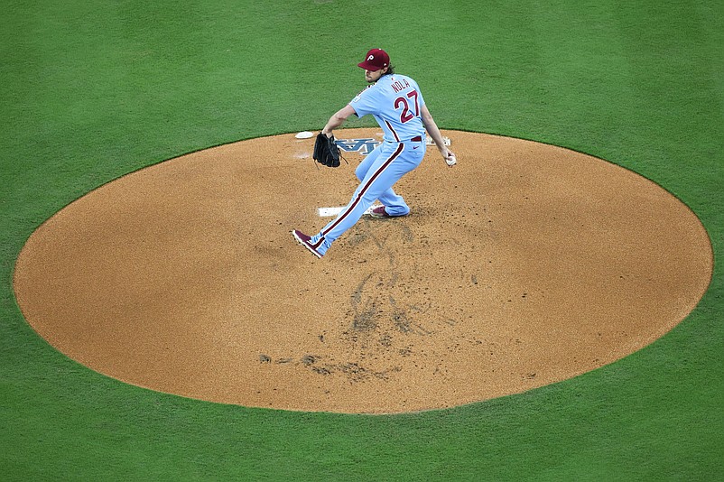 Oct 8, 2025; Los Angeles, California, USA; Philadelphia Phillies pitcher Aaron Nola (27) pitches during the first inning against the Los Angeles Dodgers during game three of the NLDS round for the 2025 MLB playoffs at Dodger Stadium. Mandatory Credit: Kiyoshi Mio-Imagn Images