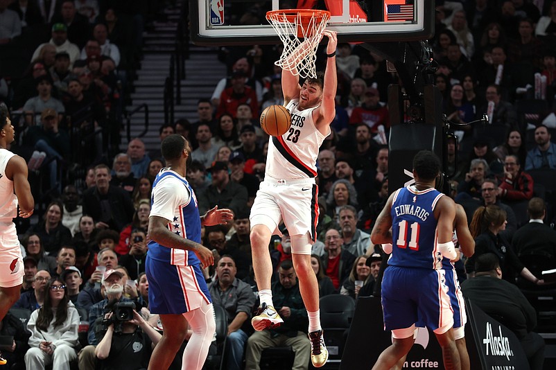 Feb 9, 2026; Portland, Oregon, USA;  Portland Trail Blazers center Donovan Clingan (23) dunks the ball against the Philadelphia 76ers during the second half at Moda Center. Mandatory Credit: Jaime Valdez-Imagn Images