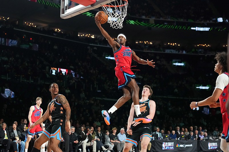 Feb 13, 2026; Inglewood, California, USA; Team Vince guard VJ Edgecombe (77) of the Philadelphia 76ers shoots against Team T-Mac guard Kon Knueppel (7) of the Charlotte Hornets during an NBA All Star Rising Stars game at Intuit Dome. Mandatory Credit: Kirby Lee-Imagn Images