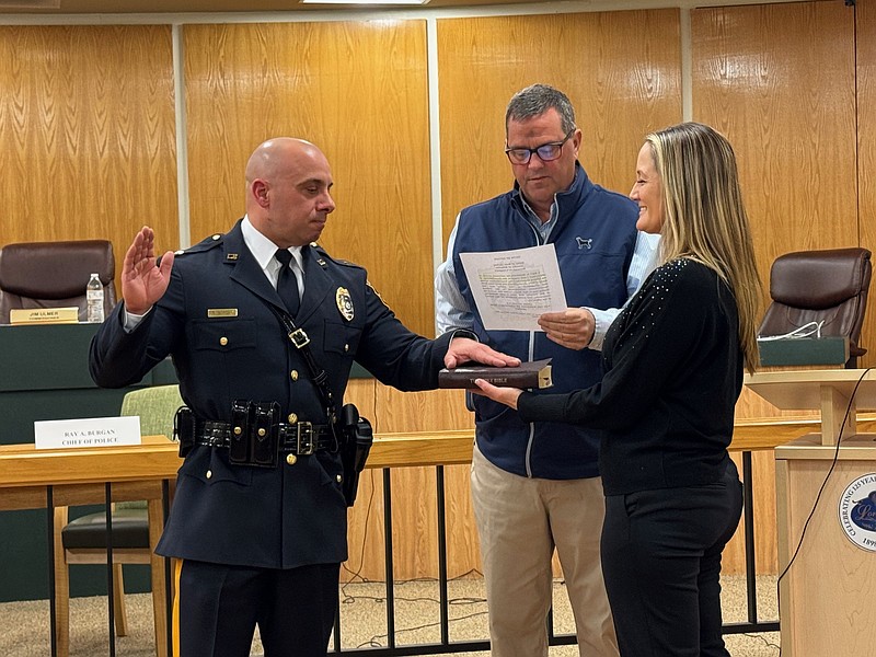 Ray Burgan takes the oath of office for the position of Chief of Longport Police. Also pictured, Commissioner of Public Safety Dan Lawler and Burgan's wife Cherie, a captain in the Egg Harbor Township Police Department.
