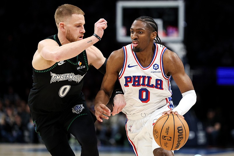 Feb 22, 2026; Minneapolis, Minnesota, USA; Philadelphia 76ers guard Tyrese Maxey (0) works around Minnesota Timberwolves guard Donte DiVincenzo (0) during the first half at Target Center. Mandatory Credit: Matt Krohn-Imagn Images