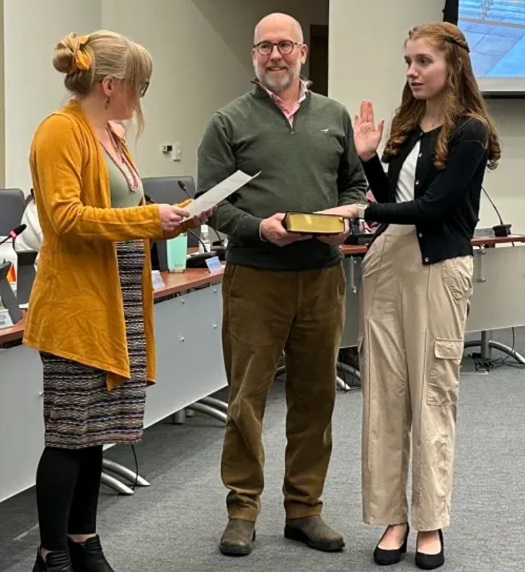 Lansdale junior councilperson Anna Szekely, right, receives her oath from Mayor Rachael Bollens as her father Andy, center, holds a Bible during the council meeting on Wednesday, Feb. 18, 2026. (Photo courtesy of Lansdale Borough)