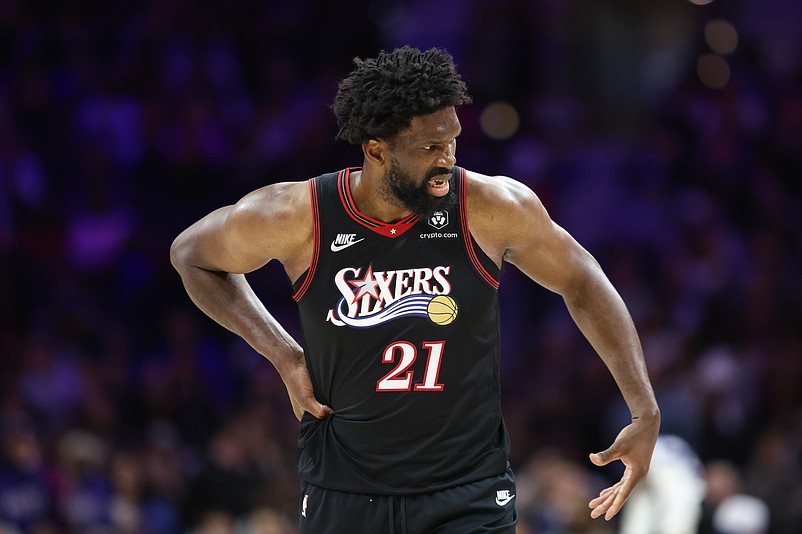 Feb 26, 2026; Philadelphia, Pennsylvania, USA; Philadelphia 76ers center Joel Embiid (21) reacts while clutching his body after a play against the Miami Heat during the second quarter at Xfinity Mobile Arena. Mandatory Credit: Bill Streicher-Imagn Images