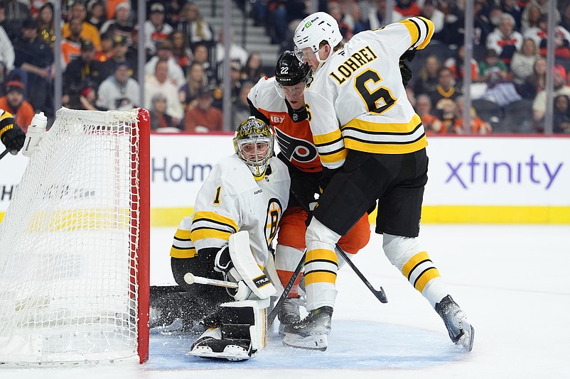 Feb 28, 2026; Philadelphia, Pennsylvania, USA; Philadelphia Flyers center Christian Dvorak (22) collides with Boston Bruins goalie Jeremy Swayman (1) and defenseman Mason Lohrei (6) in the second period at Xfinity Mobile Arena. Mandatory Credit: Kyle Ross-Imagn Images