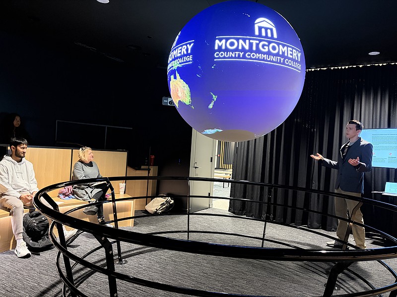 Students in the Communications 110 course at Montgomery County Community College watch a presentation displayed on the Science on a Sphere® in the lobby of South Hall on the Pottstown Campus. Photo by Eric Devlin