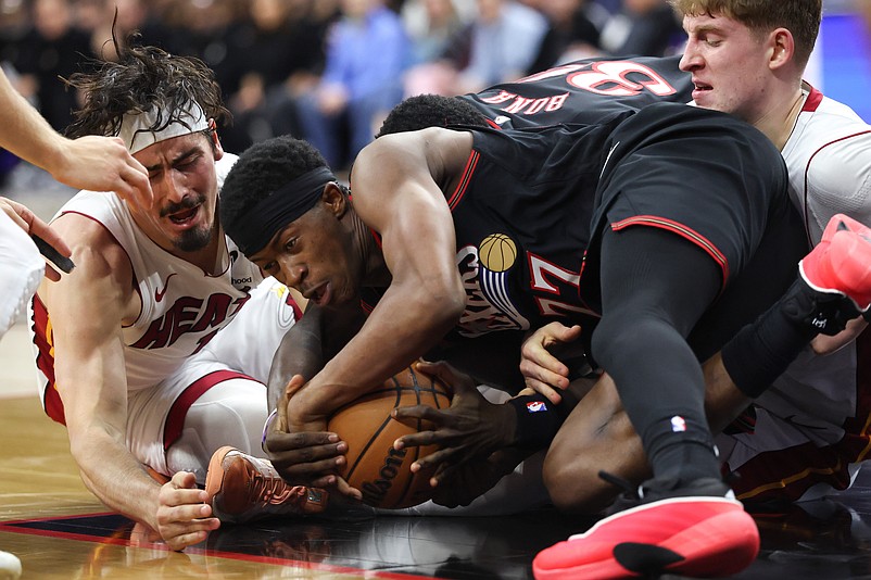 Feb 26, 2026; Philadelphia, Pennsylvania, USA; Philadelphia 76ers guard Vj Edgecombe (77) dives for a loose ball against Miami Heat forward Jaime Jaquez Jr. (11) during the fourth quarter at Xfinity Mobile Arena. Mandatory Credit: Bill Streicher-Imagn Images