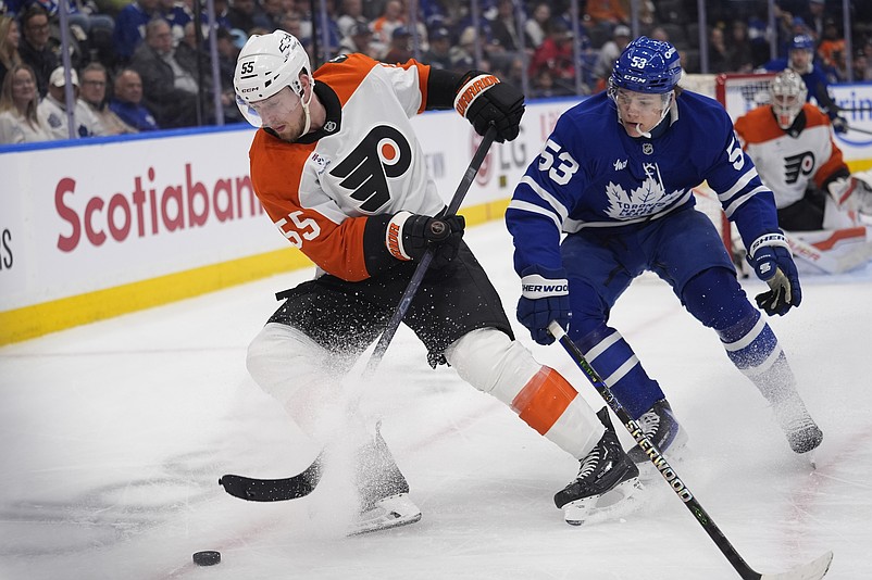 Mar 2, 2026; Toronto, Ontario, CAN; Philadelphia Flyers defenseman Rasmus Ristolainen (55) battles with Toronto Maple Leafs forward Easton Cowan (53) to get control of the puck during the third period at Scotiabank Arena. Mandatory Credit: John E. Sokolowski-Imagn Images