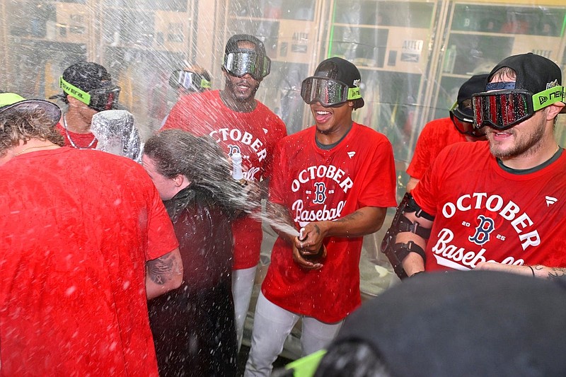 Sep 26, 2025; Boston, Massachusetts, USA; Boston Red Sox players celebrate clinching a playoff spot in the clubhouse after winning their game against the Detroit Tigers at Fenway Park. Mandatory Credit: Eric Canha-Imagn Images