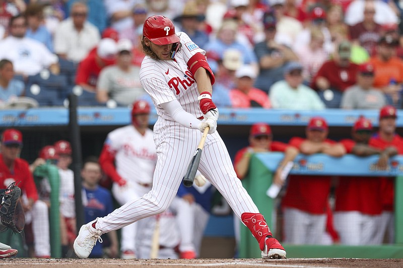 Mar 12, 2026; Clearwater, Florida, USA; Philadelphia Phillies first baseman Alec Bohm (28) hots a ground out rbi against the Toronto Blue Jays in the first inning during spring training at BayCare Ballpark. Mandatory Credit: Nathan Ray Seebeck-Imagn Images