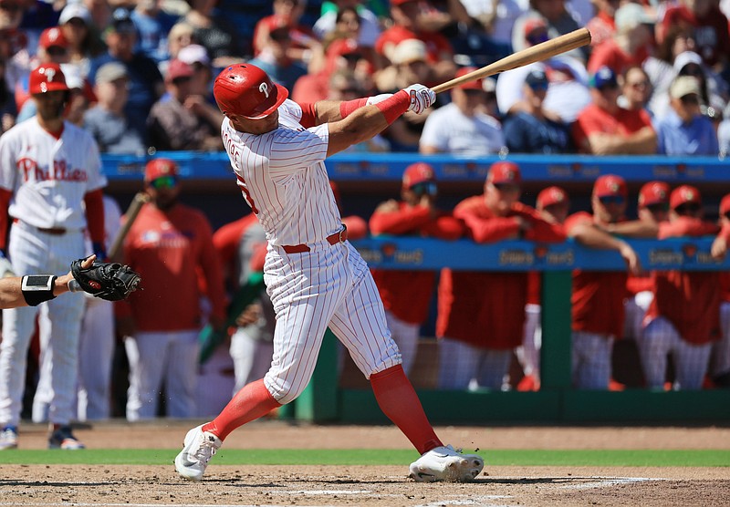 Mar 5, 2026; Clearwater, Florida, USA;  Philadelphia Phillies designated hitter Dylan Moore (25) hits a 2-RBI single during the second inning against the Boston Red Sox at BayCare Ballpark. Mandatory Credit: Kim Klement Neitzel-Imagn Images