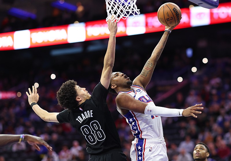 Mar 14, 2026; Philadelphia, Pennsylvania, USA; Philadelphia 76ers forward Justin Edwards (11) drives for a shot past Brooklyn Nets guard Nolan Traore (88) during the fourth quarter at Xfinity Mobile Arena. Mandatory Credit: Bill Streicher-Imagn Images