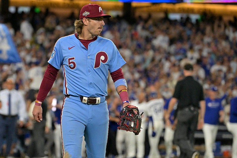 Oct 9, 2025; Los Angeles, California, USA; Philadelphia Phillies second baseman Bryson Stott (5) walks off the field as he watches the celebration by the Los Angeles Dodgers after the 11th inning and winning game four of the NLDS in the 2025 MLB playoffs at Dodger Stadium. Mandatory Credit: Jayne Kamin-Oncea-Imagn Images