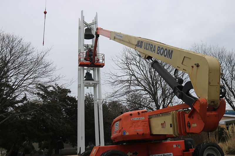 A large crane carefully lowers the brass bells from the 100-foot-tall tower at the Ocean City Tabernacle.