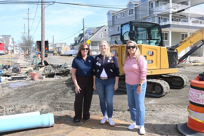From left, Sea Isle City residents Terry Propper, Beth Pearce and Lori Branco stand in the middle of drainage construction at the corner of 46h Street and Central Avenue near their homes. The photo was taken March 10, when construction was more intense.