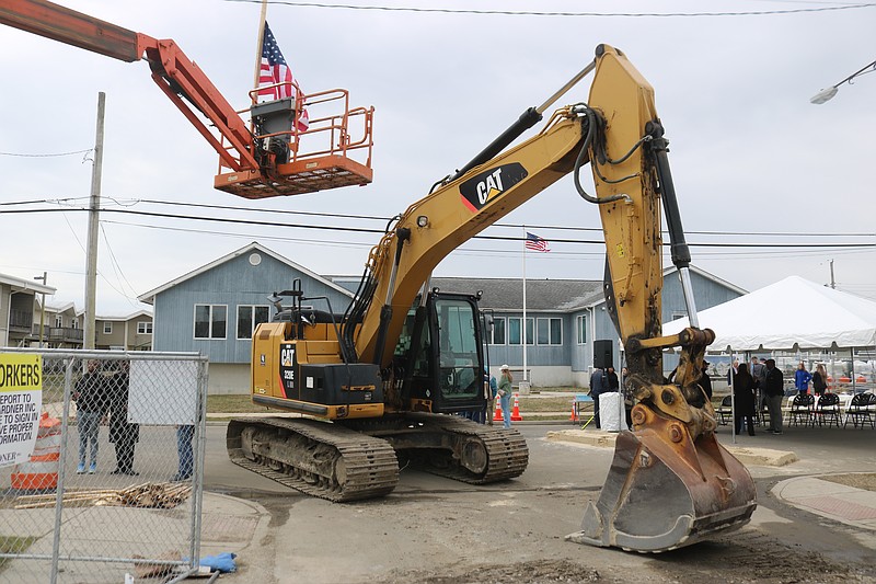 A giant excavator sits at the entrance of the Pecks Beach Village construction site on Fourth Street.