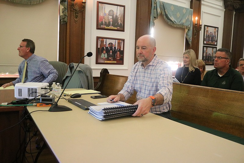 Chief Financial Officer Frank Donato looks at copies of the 2026 budget while preparing to give his presentation to City Council.