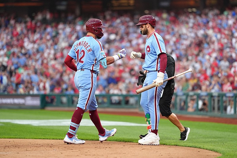 Aug 28, 2025; Philadelphia, Pennsylvania, USA; Philadelphia Phillies designated hitter Kyle Schwarber (12) reacts with infielder Bryce Harper (3) after hitting a home run against the Atlanta Braves in the first inning at Citizens Bank Park. Mandatory Credit: Kyle Ross-Imagn Images