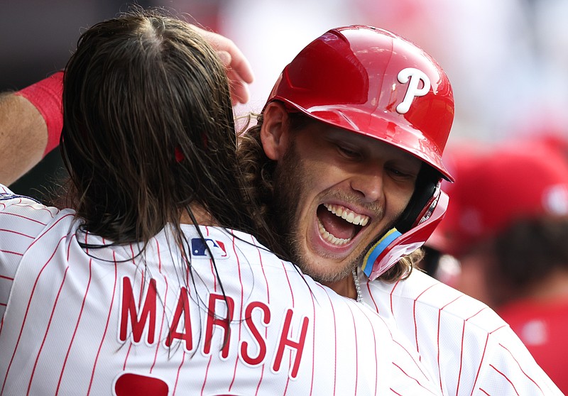 Mar 26, 2026; Philadelphia, Pennsylvania, USA; Philadelphia Phillies third baseman Alec Bohm (28) celebrates with center fielder Brandon Marsh (16) in the dugout after hitting a three RBI home run during the fifth inning against the Texas Rangers at Citizens Bank Park. Mandatory Credit: Bill Streicher-Imagn Images