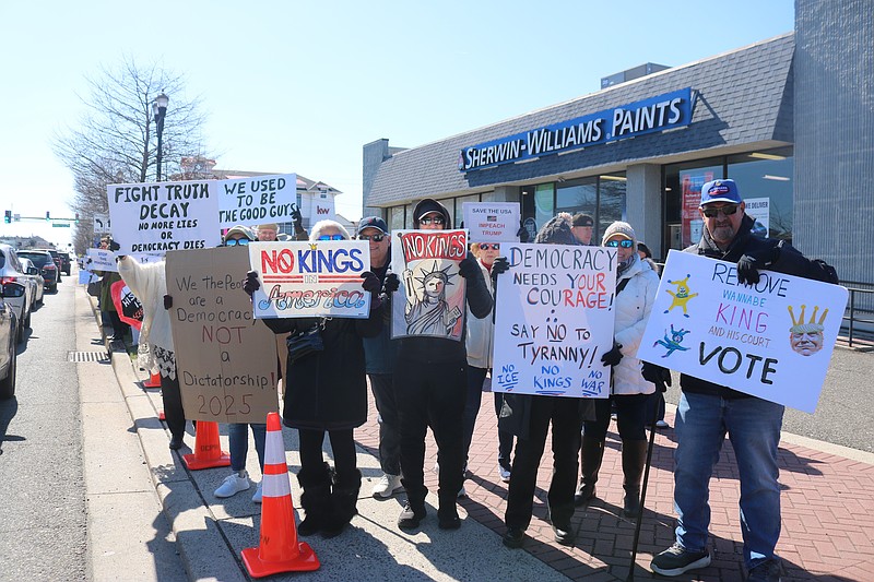No Kings protesters occupy the sidewalk on Ninth Street.