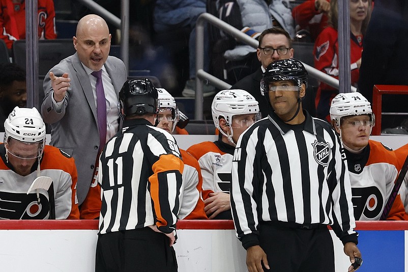 Mar 31, 2026; Washington, District of Columbia, USA; Philadelphia Flyers head coach Rick Tocchet argues with referee Kelly Sutherland (11) during a stoppage in play against the Washington Capitals during the second period at Capital One Arena. Mandatory Credit: Geoff Burke-Imagn Images