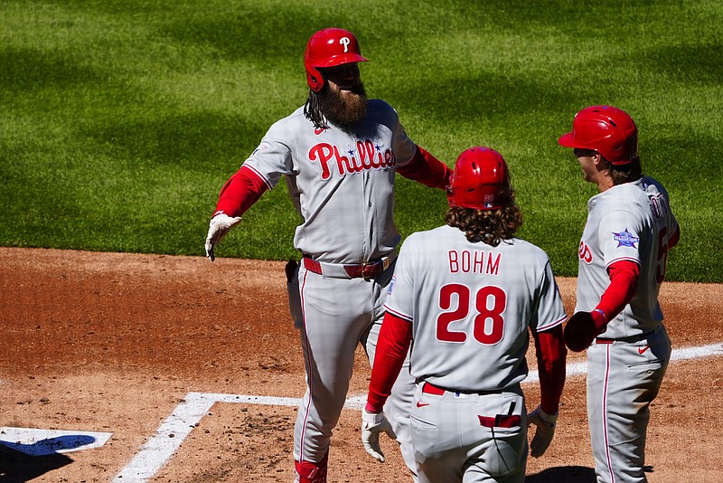 Apr 3, 2026; Denver, Colorado, USA; Philadelphia Phillies center fielder Brandon Marsh (16) celebrates his three run home run with second baseman Bryson Stott (5) and third baseman Alec Bohm (28) in the first inning against the Colorado Rockies at Coors Field. Mandatory Credit: Ron Chenoy-Imagn Images