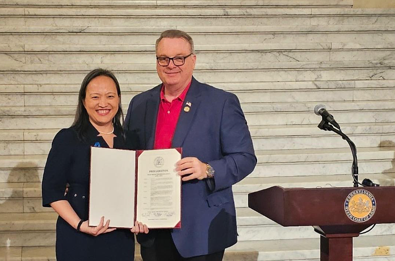 Montgomery County Commissioner Tom DiBello, right, presents a commendation to Mission Kids Child Advocacy Center representative Jane Kim during a ceremony on April 1 in Harrisburg. (Photo courtesy Mission Kids Child Advocacy Center)
