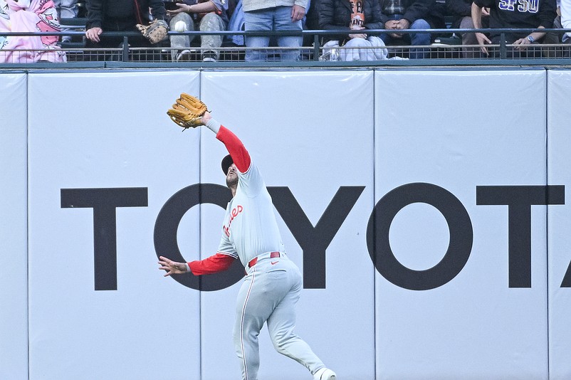 Apr 7, 2026; San Francisco, California, USA; Philadelphia Phillies outfielder Otto Kemp (4) catches a fly ball in left field during the second inning of the game against the San Francisco Giants at Oracle Park. Mandatory Credit: Ed Szczepanski-Imagn Images