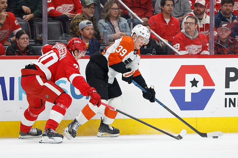 Mar 28, 2026; Detroit, Michigan, USA;  Philadelphia Flyers right wing Matvei Michkov (39) skates with the puck defended by Detroit Red Wings defenseman Albert Johansson (20) in the first period at Little Caesars Arena. Mandatory Credit: Rick Osentoski-Imagn Images