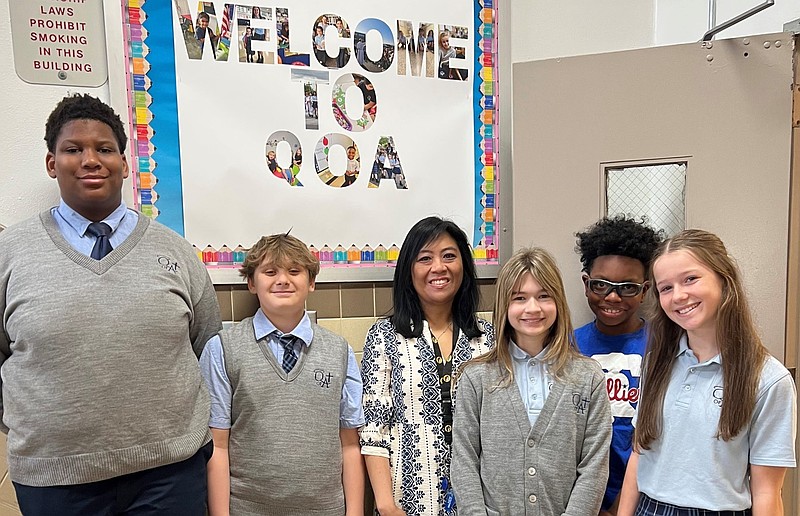 Christina Behan, a teacher at Queen of Angels Regional Catholic School in Willow Grove, poses with some of her students. Behan is awaiting a kidney transplant and has received widespread prayer and support from her school and parish community. (Courtesy Photo)