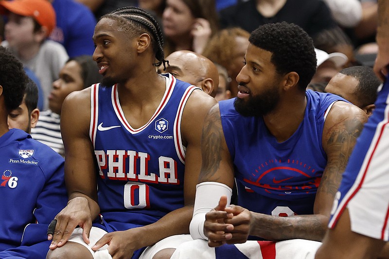 Apr 1, 2026; Washington, District of Columbia, USA; Philadelphia 76ers guard Tyrese Maxey (0) and 76ers forward Paul George (8) look on from the bench against the Washington Wizards in the second half at Capital One Arena. Mandatory Credit: Geoff Burke-Imagn Images