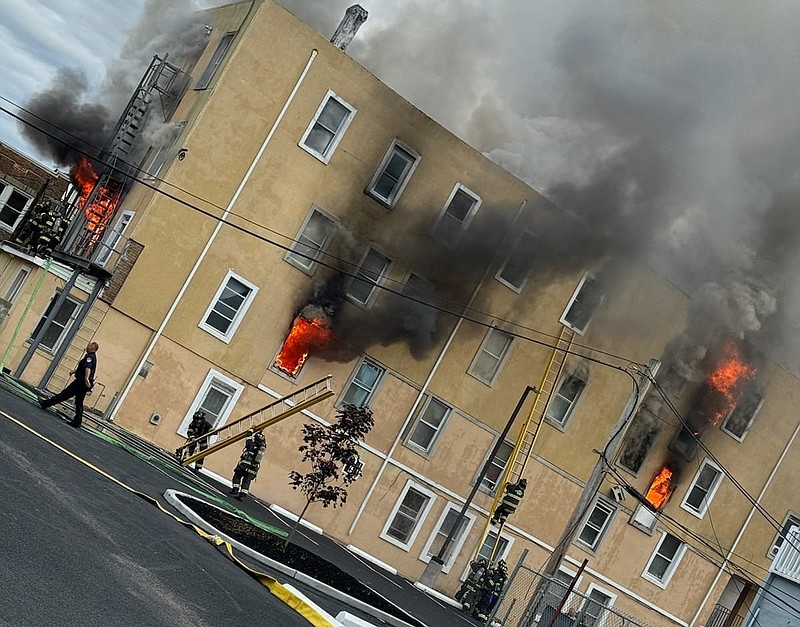 Atlantic City firefighters ready for a ladder rescue July 11, 2024, at a 100-year-old rooming house on South Georgia Avenue. (John Varallo photo)