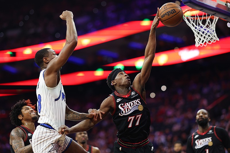 Apr 15, 2026; Philadelphia, Pennsylvania, USA; Philadelphia 76ers guard Vj Edgecombe (77) reaches for a loose ball against Orlando Magic forward Jamal Cain (8) during the first quarter of the play-in rounds of the 2026 NBA Playoffs at Xfinity Mobile Arena. Mandatory Credit: Bill Streicher-Imagn Images