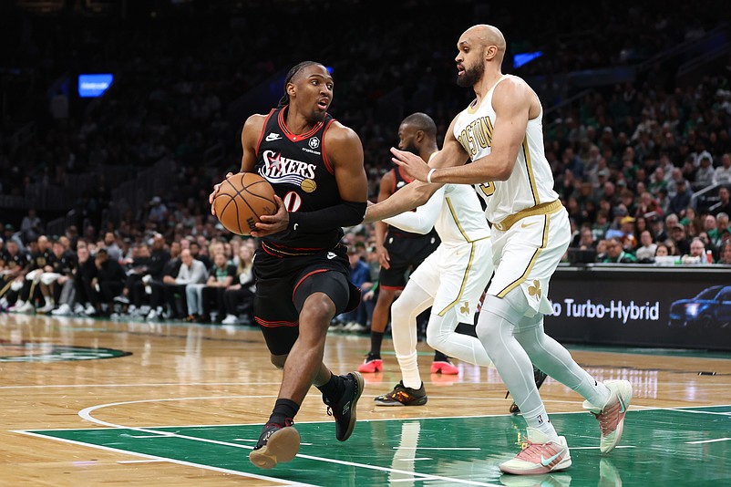 Mar 1, 2026; Boston, Massachusetts, USA; Philadelphia 76ers guard Tyrese Maxey (0) drives to the basket defended by Boston Celtics guard Derrick White (9) during the first half at TD Garden. Mandatory Credit: Paul Rutherford-Imagn Images