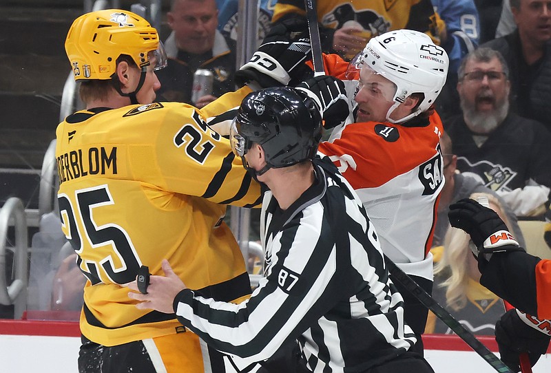 Apr 18, 2026; Pittsburgh, Pennsylvania, USA; Pittsburgh Penguins left wing Elmer Soderblom (25) and Philadelphia Flyers defenseman Travis Sanheim (6) tussle as linesman linesman Devin Berg (87) separates the two during the first period against in game one of the first round of the 2026 Stanley Cup Playoffs at PPG Paints Arena. Mandatory Credit: Charles LeClaire-Imagn Images