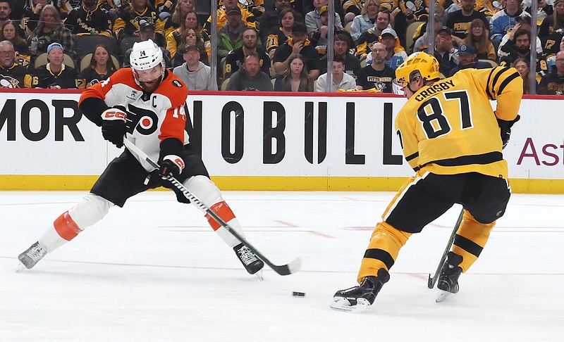 Apr 18, 2026; Pittsburgh, Pennsylvania, USA; Philadelphia Flyers center Sean Couturier (14) moves the puck against Pittsburgh Penguins center Sidney Crosby (87) during the second period in game one of the first round of the 2026 Stanley Cup Playoffs at PPG Paints Arena. Mandatory Credit: Charles LeClaire-Imagn Images
