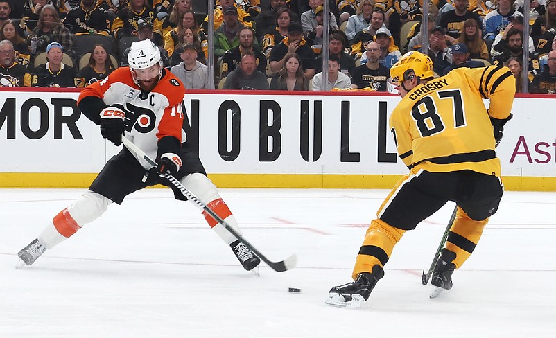 Apr 18, 2026; Pittsburgh, Pennsylvania, USA; Philadelphia Flyers center Sean Couturier (14) moves the puck against Pittsburgh Penguins center Sidney Crosby (87) during the second period in game one of the first round of the 2026 Stanley Cup Playoffs at PPG Paints Arena. Mandatory Credit: Charles LeClaire-Imagn Images