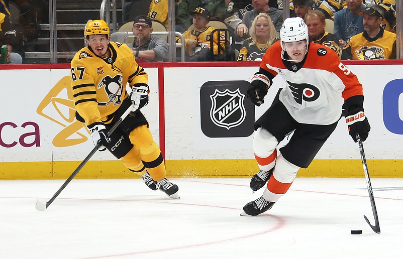 Apr 18, 2026; Pittsburgh, Pennsylvania, USA; Philadelphia Flyers defenseman Jamie Drysdale (9) moves the puck against Pittsburgh Penguins right wing Rickard Rakell (67) during the third period in game one of the first round of the 2026 Stanley Cup Playoffs at PPG Paints Arena. Mandatory Credit: Charles LeClaire-Imagn Images