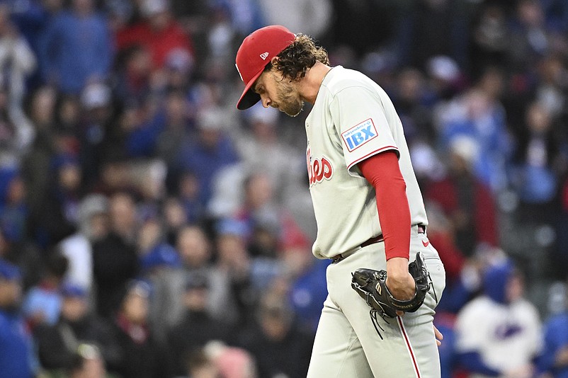 Apr 20, 2026; Chicago, Illinois, USA;  Philadelphia Phillies pitcher Aaron Nola (27) looks down after Chicago Cubs shortstop Dansby Swanson (not pictured) hits a three run home during the second inning at Wrigley Field. Mandatory Credit: Matt Marton-Imagn Images