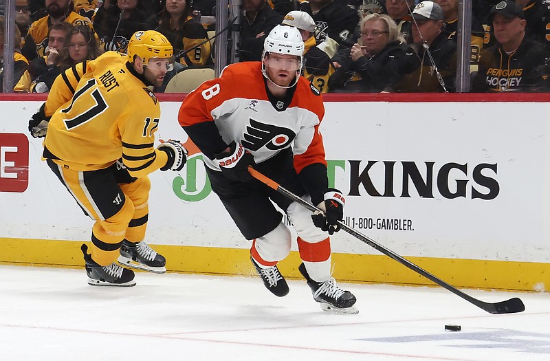 Apr 20, 2026; Pittsburgh, Pennsylvania, USA;  Philadelphia Flyers defenseman Cam York (8) moves the puck against Pittsburgh Penguins right wing Bryan Rust (17) during the third period in game two of the first round of the 2026 Stanley Cup Playoffs at PPG Paints Arena. Mandatory Credit: Charles LeClaire-Imagn Images