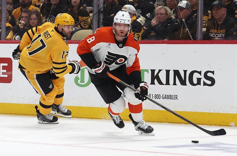Apr 20, 2026; Pittsburgh, Pennsylvania, USA;  Philadelphia Flyers defenseman Cam York (8) moves the puck against Pittsburgh Penguins right wing Bryan Rust (17) during the third period in game two of the first round of the 2026 Stanley Cup Playoffs at PPG Paints Arena. Mandatory Credit: Charles LeClaire-Imagn Images