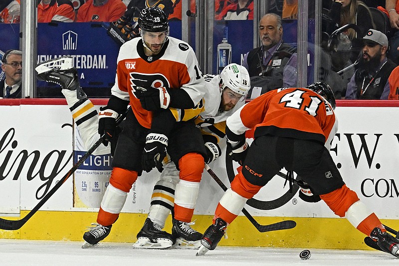 Apr 22, 2026; Philadelphia, Pennsylvania, USA; Pittsburgh Penguins right wing Justin Brazeau (16) battles for the puck with Philadelphia Flyers right wing Garnet Hathaway (19) and center Luke Glendening (41) during the first period in game three of the first round of the 2026 Stanley Cup Playoffs at Xfinity Mobile Arena. Mandatory Credit: Eric Hartline-Imagn Images