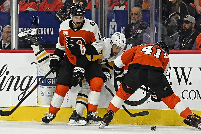 Apr 22, 2026; Philadelphia, Pennsylvania, USA; Pittsburgh Penguins right wing Justin Brazeau (16) battles for the puck with Philadelphia Flyers right wing Garnet Hathaway (19) and center Luke Glendening (41) during the first period in game three of the first round of the 2026 Stanley Cup Playoffs at Xfinity Mobile Arena. Mandatory Credit: Eric Hartline-Imagn Images