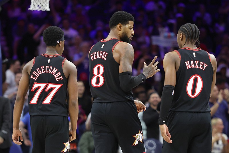 Apr 15, 2026; Philadelphia, Pennsylvania, USA; Philadelphia 76ers forward Paul George (8) talks with guard Tyrese Maxey (0) and guard Vj Edgecombe (77) during a break in action against the Orlando Magic in the third quarter of a play-in round of the 2026 NBA Playoffs at Xfinity Mobile Arena. Mandatory Credit: Bill Streicher-Imagn Images