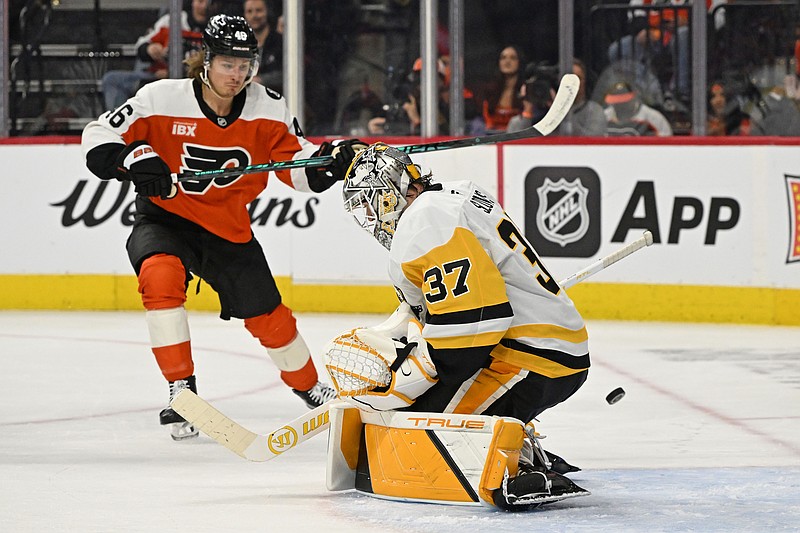 Apr 25, 2026; Philadelphia, Pennsylvania, USA; Pittsburgh Penguins goaltender Arturs Silovs (37) makes a save as Philadelphia Flyers center Trevor Zegras (46) looks on during the first period in game four of the first round of the 2026 Stanley Cup Playoffs at Xfinity Mobile Arena. Mandatory Credit: Eric Hartline-Imagn Images