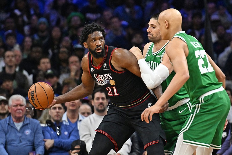 Apr 26, 2026; Philadelphia, Pennsylvania, USA; Philadelphia 76ers center Joel Embiid (21) is defended by Boston Celtics center Nikola Vucevic (4) during the first half at Xfinity Mobile Arena. Mandatory Credit: Eric Hartline-Imagn Images