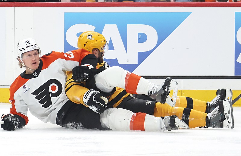Apr 27, 2026; Pittsburgh, Pennsylvania, USA;  Philadelphia Flyers center Christian Dvorak (22) and Pittsburgh Penguins right wing Bryan Rust (rear) get tangled up during the first period in game five of the first round of the 2026 Stanley Cup Playoffs at PPG Paints Arena. Mandatory Credit: Charles LeClaire-Imagn Images