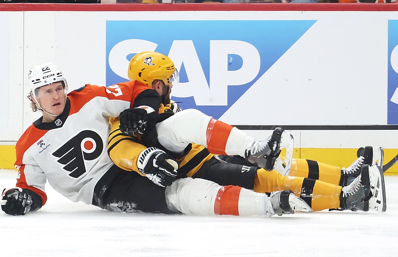 Apr 27, 2026; Pittsburgh, Pennsylvania, USA;  Philadelphia Flyers center Christian Dvorak (22) and Pittsburgh Penguins right wing Bryan Rust (rear) get tangled up during the first period in game five of the first round of the 2026 Stanley Cup Playoffs at PPG Paints Arena. Mandatory Credit: Charles LeClaire-Imagn Images